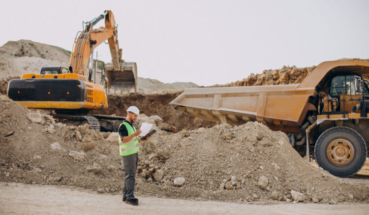 Male worker with bulldozer in sand quarry